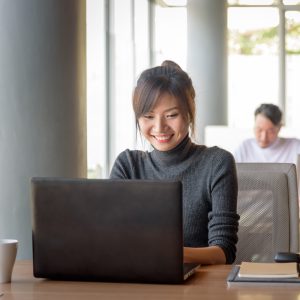 Smiling woman on laptop