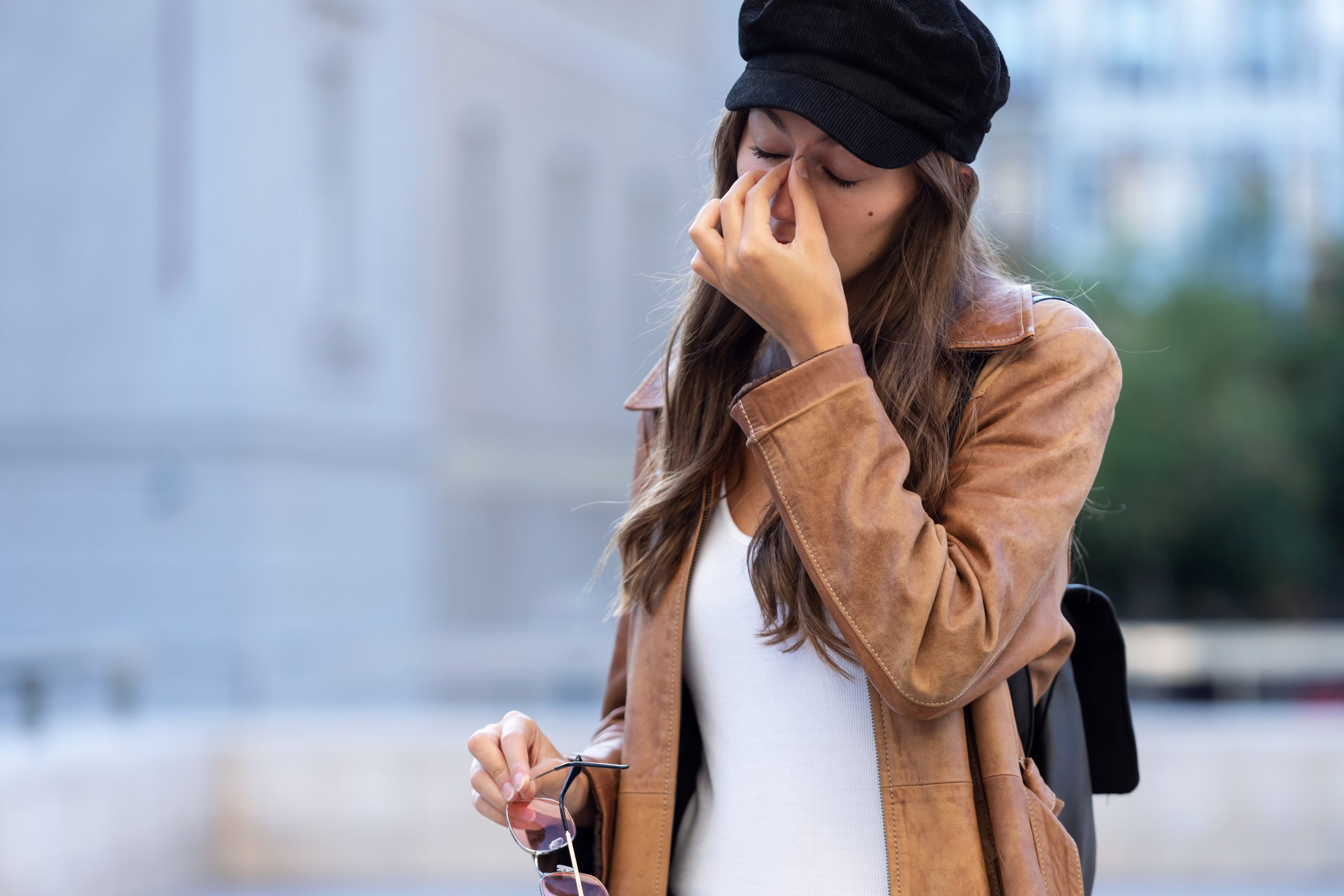 Young woman suffering from female infertility hand on face