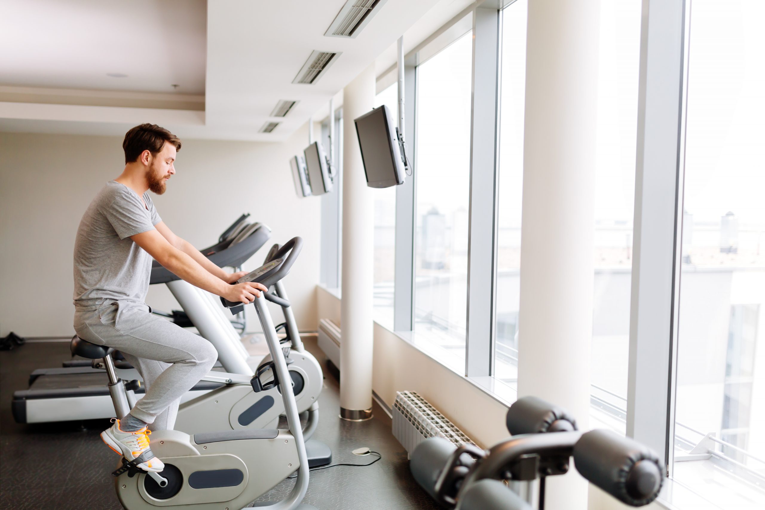Man exercising on workout bike to improve his sperm count