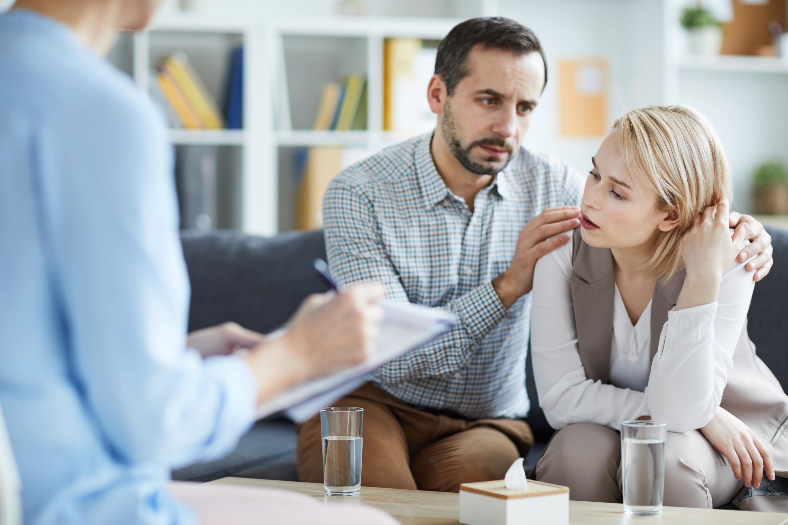 Stressed wife and husband at fertility consultation discussing mental health